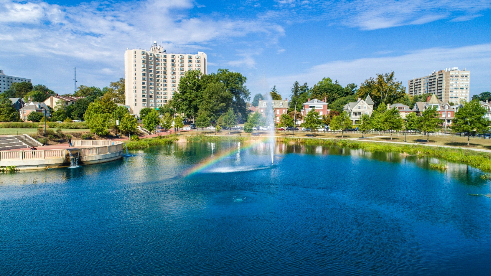 Fountain in the Middle of a Pond Catching the Sunday Makign a Rainbow